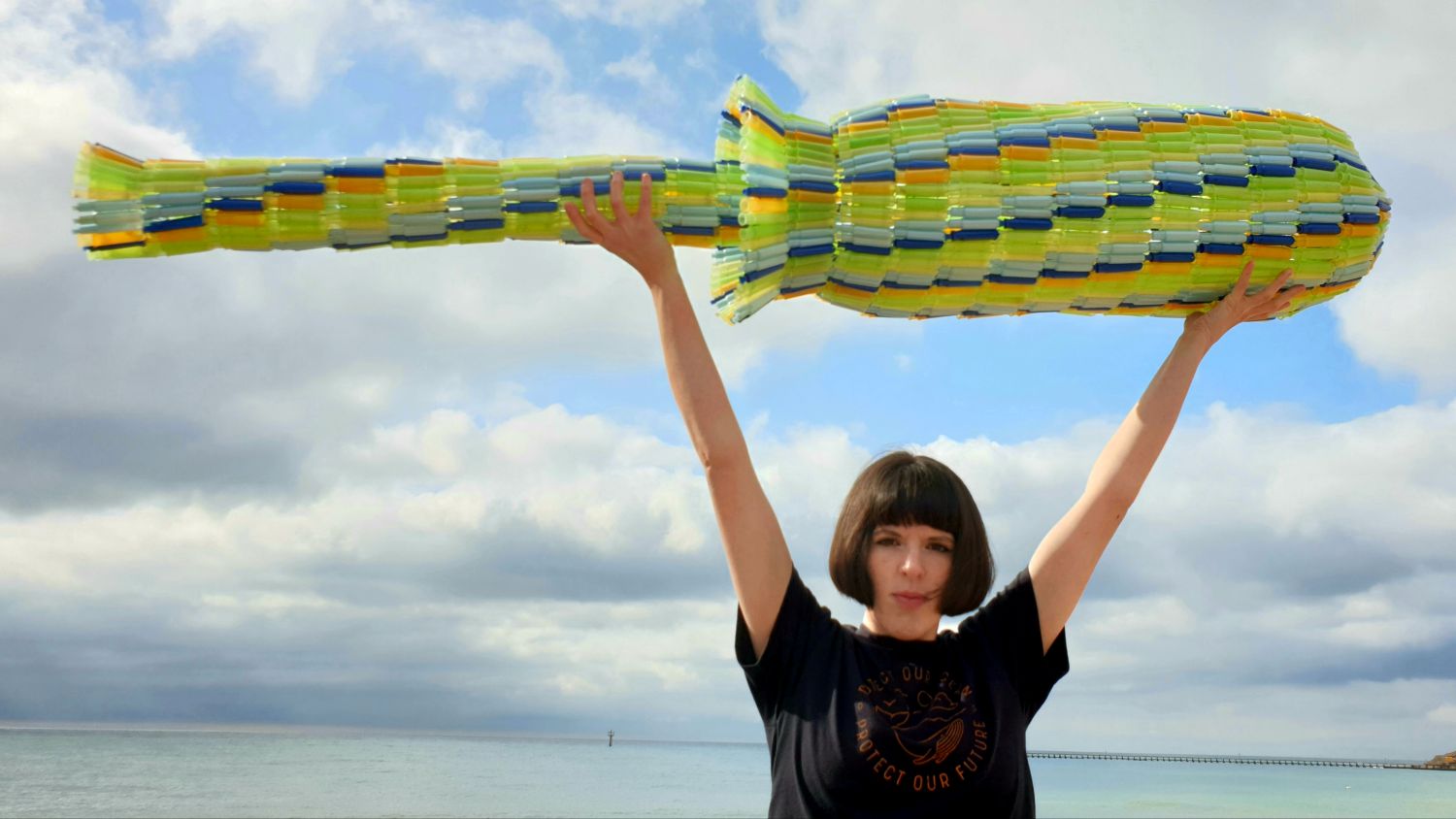Ella Daish holding a giant tampon applicator made from discarded applicators.