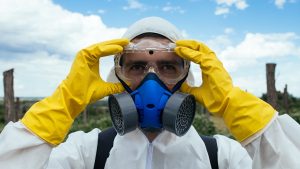 Putting on protective clothing for spraying cotton with pesticides