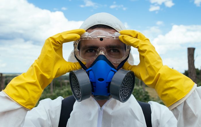 Putting on protective clothing for spraying cotton with pesticides